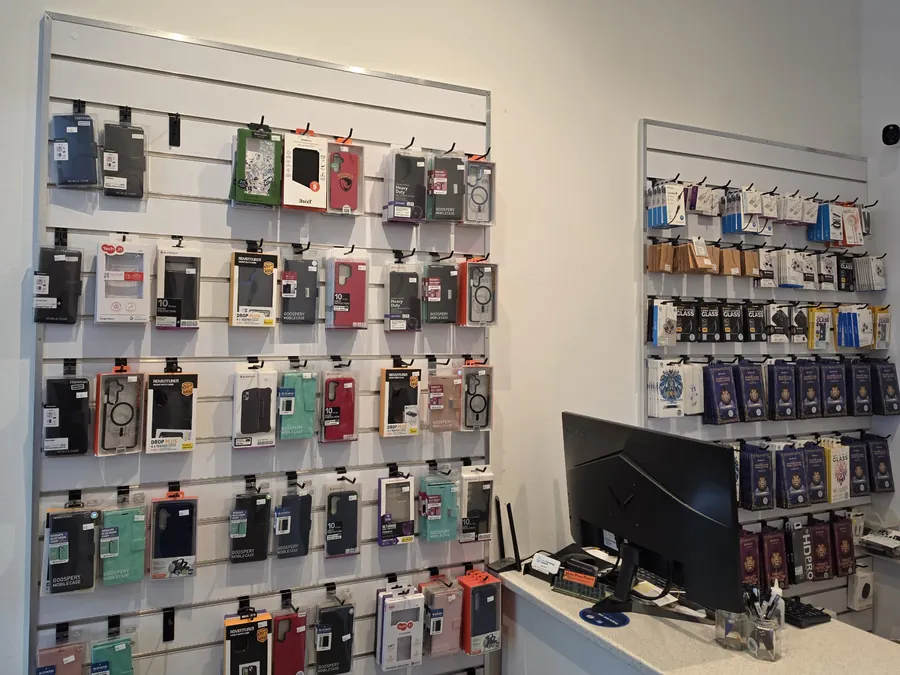 Inside Mobile Phone Repairs Coffs Harbour: phone case and screen protector wall beside the counter