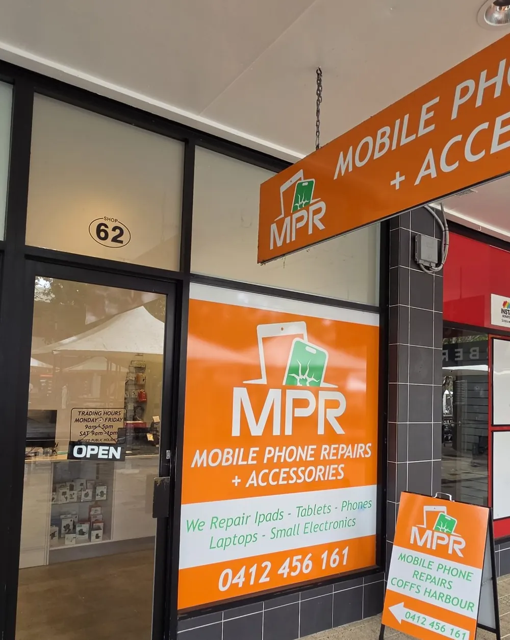 Shopfront of Mobile Phone Repairs Coffs Harbour at Shop 62, City Centre Square (The Mall), Coffs Harbour, with the orange hanging sign and window sign